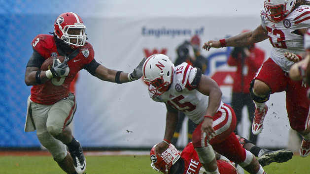 Jan 1, 2014; Jacksonville, FL, USA; Georgia Bulldogs tailback Todd Gurley (3) runs the ball against Nebraska Cornhuskers linebacker Michael Rose (15) as he runs for a first down in the fourth quarter of their game at EverBank Field. The Nebraska Cornhuskers beat the Georgia Bulldogs 24-19. Mandatory Credit: Phil Sears-USA TODAY Sports