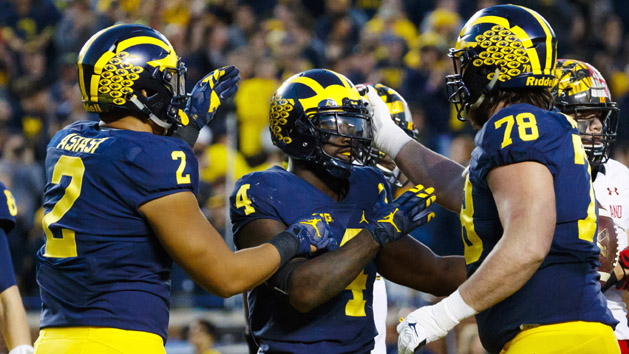 Nov 5, 2016; Ann Arbor, MI, USA; Michigan Wolverines running back De'Veon Smith (4) receives congratulations from tight end Devin Asiasi (2) and offensive lineman Erik Magnuson (78) after scoring a touchdown in the second half against the Maryland Terrapins at Michigan Stadium. Michigan 59-3. Photo Credit: Rick Osentoski-USA TODAY Sports