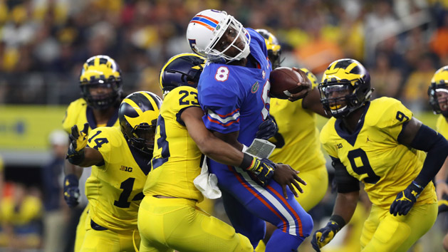 Sep 2, 2017; Arlington, TX, USA; Florida Gators quarterback Malik Zaire (8) is tackled on a run by Michigan Wolverines cornerback Lavert Hill (23) at AT&T Stadium. Photo Credit: Matthew Emmons-USA TODAY Sports