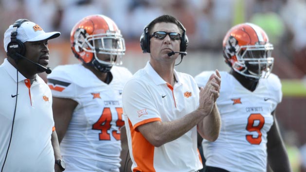 Sep 26, 2015; Austin, TX, USA; Oklahoma State Cowboys head coach Mike Gundy (center) reacts against the Texas Longhorns during the second quarter at Darrell K Royal-Texas Memorial Stadium. Mandatory Credit: Brendan Maloney-USA TODAY Sports
