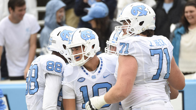 Sep 26, 2015; Chapel Hill, NC, USA; North Carolina Tar Heels quarterback Mitch Trubisky (10) celebrates in the end zone with wide receiver Jordan Fieulleteau (88) and offensive tackle Jon Heck (71) after throwing a touchdown pass to wide receiver Ryan Switzer (3) (not pictured) in the fourth quarter. The Tar Heels defeated the Delaware Fightin Blue Hens 41-14 at Kenan Memorial Stadium. Photo Credit: Bob Donnan-USA TODAY Sports