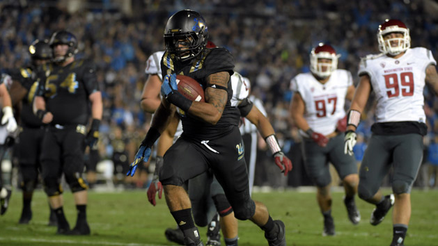 Nov 14, 2015; Pasadena, CA, USA; UCLA Bruins running back Nate Starks (23) scores on a 14-yard touchdown run in the second quarter against the Washington State Cougars in a NCAA football game at Rose Bowl. Mandatory Credit: Kirby Lee-USA TODAY Sports