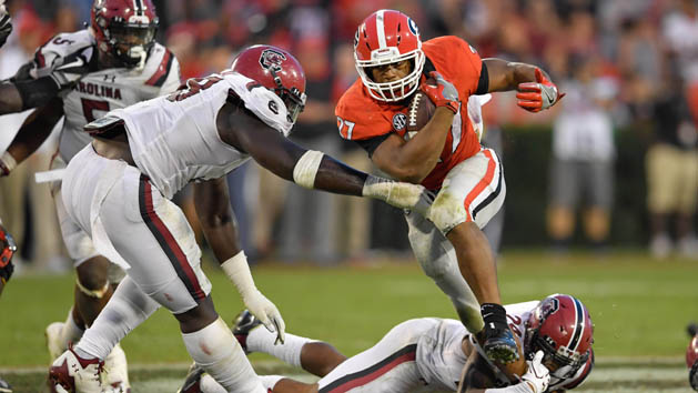 Nov 4, 2017; Athens, GA, USA; Georgia Bulldogs running back Nick Chubb (27) breaks a tackle by South Carolina Gamecocks defensive back D.J. Smith (24) during the second half at Sanford Stadium. Photo Credit: Dale Zanine-USA TODAY Sports