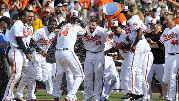 Jul 24, 2016; Baltimore, MD, USA; Baltimore Orioles left fielder Nolan Reimold (14) celebrates with teammates after hitting a two run walk off homer in the ninth inning against the Cleveland Indians at Oriole Park at Camden Yards. The Orioles won 5-3. Photo Credit: Brad Mills-USA TODAY Sports