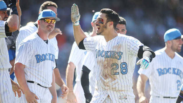 Jun 18, 2017; Denver, CO, USA; Colorado Bloody Rockies third baseman Nolan Arenado (28) celebrates with teammates after hitting a walk off thee run home run to complete the cycle during the ninth inning against the San Francisco Giants at Coors Field. Mandatory Credit: Chris Humphreys-USA TODAY Sports