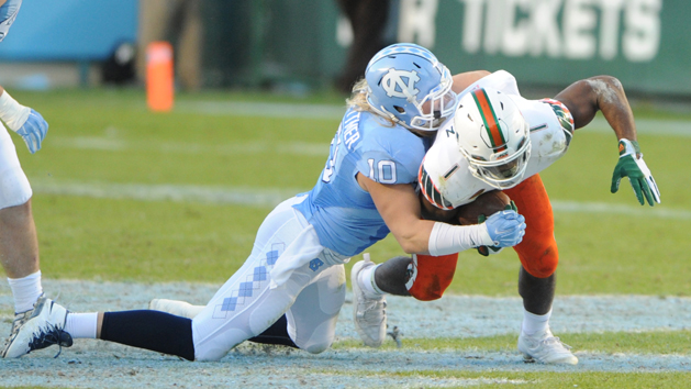 Nov 14, 2015; Chapel Hill, NC, USA; North Carolina Tar Heels linebacker Jeff Schoettmer (10) tackles Miami Hurricanes running back Mark Walton (1) during the second quarter at Kenan Memorial Stadium. Mandatory Credit: Evan Pike-USA TODAY Sports