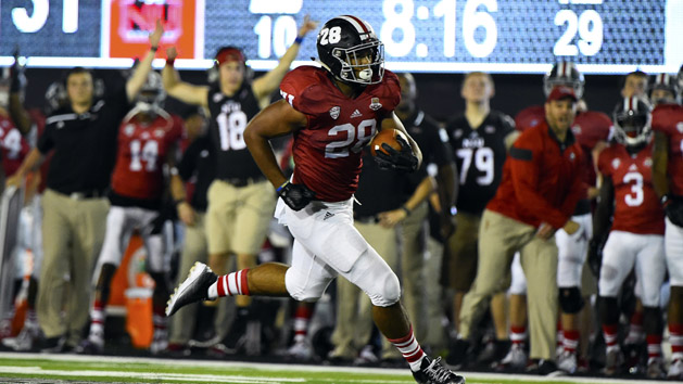 Sep 5, 2015; DeKalb, IL, USA; Northern Illinois Huskies running back Joel Bouagnon (28) rushes for a touchdown against the UNLV Rebels during the fourth quarter at Huskie Stadium. Northern Illinois defeats UNLV 38-30. Mandatory Credit: Mike DiNovo-USA TODAY Sports