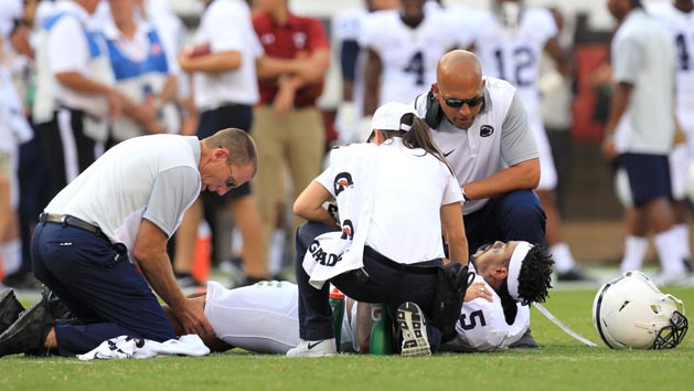Sep 5, 2015; Philadelphia, PA, USA; Penn State Nittany Lions linebacker Nyeem Wartman-White (5) reacts while trainers work on his leg as head coach James Franklin looks during the second quarter against the Temple Owl at Lincoln Financial Field. Photo Credit: Matthew O'Haren-USA TODAY Sports