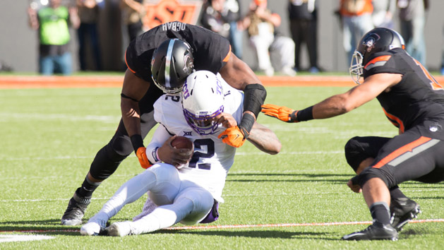 Nov 7, 2015; Stillwater, OK, USA; TCU Horned Frogs quarterback Trevone Boykin (2) tackled by Oklahoma State Cowboys defensive end Emmanuel Ogbah (38) during the first quarter at Boone Pickens Stadium. Mandatory Credit: Rob Ferguson-USA TODAY Sports