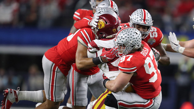 Dec 29, 2017; Arlington, TX, USA; Ohio State Buckeyes defensive end Nick Bosa (97) linebacker Malik Harrison (39) and cornerback Damon Arnette (3) tackle Southern California Trojans running back Ronald Jones II (25) during the fourth quarter in the 2017 Cotton Bowl at AT&T Stadium. Photo Credit: Matthew Emmons-USA TODAY Sports