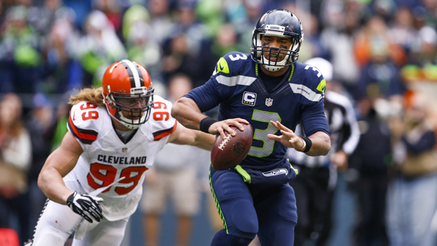 Dec 20, 2015; Seattle, WA, USA; Seattle Seahawks quarterback Russell Wilson (3) escapes from pressure brought by Cleveland Browns outside linebacker Paul Kruger (99) during the first quarter at CenturyLink Field. Photo Credit: Joe Nicholson-USA TODAY Sports