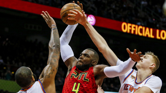 Jan 29, 2017; Atlanta, GA, USA; Atlanta Hawks forward Paul Millsap (4) is fouled by New York Knicks forward Kristaps Porzingis (6) as he tries to dunk the ball over Knicks center Kyle O'Quinn (9) during the second half at Philips Arena. Photo Credit: Butch Dill-USA TODAY Sports