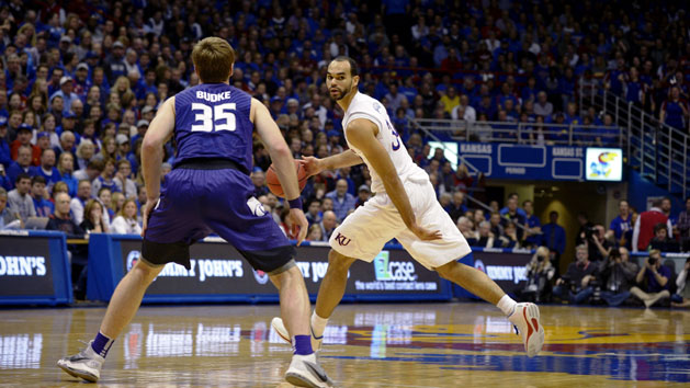Feb 3, 2016; Lawrence, KS, USA; Kansas Jayhawks forward Perry Ellis (34) moves the ball against Kansas State Wildcats forward Austin Budke (35) in the second half at Allen Fieldhouse. Kansas won the game 77-59. Mandatory Credit: John Rieger-USA TODAY Sports