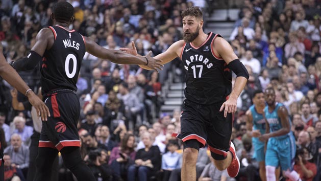 Oct 22, 2018; Toronto, Ontario, CAN; Toronto Raptors center Jonas Valanciunas (17) celebrates with Toronto Raptors forward CJ Miles (0) during the fourth quarter against the Charlotte Hornets at Scotiabank Arena. Photo Credit: Nick Turchiaro-USA TODAY Sports