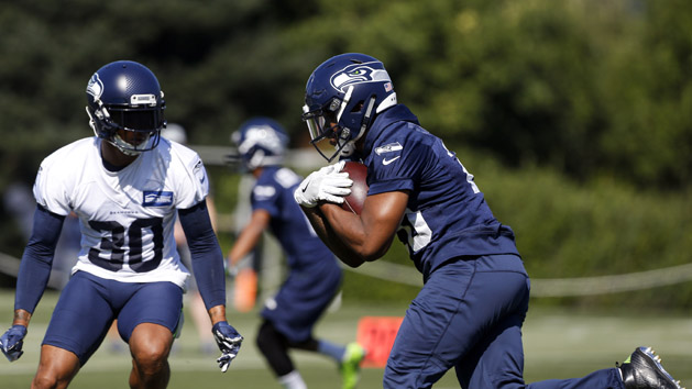 Jul 26, 2018; Renton, WA, USA; Seattle Seahawks running back Rashaad Penny (20) rushes against strong safety Bradley McDougald (30) during a training camp practice at the Virginia Mason Athletic Center. Mandatory Credit: Joe Nicholson-USA TODAY Sports