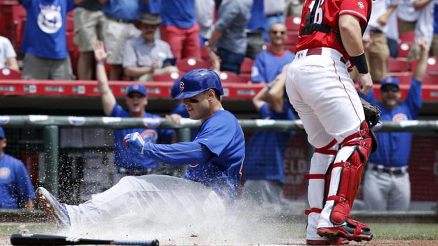 Jun 29, 2016; Cincinnati, OH, USA; Chicago Cubs first baseman Anthony Rizzo (L) scores after an inside-the-park three run home run during the first inning at Great American Ball Park. Cincinnati Reds catcher Tucker Barnhart (16) waits at right. Photo Credit: David Kohl-USA TODAY Sports