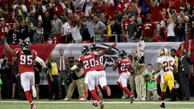 Oct 11, 2015; Atlanta, GA, USA; Atlanta Falcons defensive tackle Jonathan Babineaux (95) and defensive back Phillip Adams (20) celebrate as cornerback Robert Alford (23, right) returns an interception for a touchdown to win the game in overtime against the Washington Redskins at the Georgia Dome. The Falcons won 25-19 in overtime. Mandatory Credit: Jason Getz-USA TODAY Sports