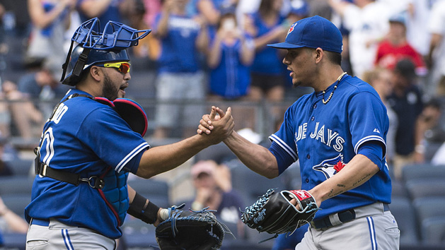 Aug 9, 2015; Bronx, NY, USA; Toronto Blue Jays catcher Dioner Navarro (30) congratulates Toronto Blue Jays pitcher Roberto Osuna (54) on getting the save after the ninth inning of the game at Yankee Stadium. The Blue Jays won 2-0. Photo Credit: Gregory J. Fisher-USA TODAY Sports