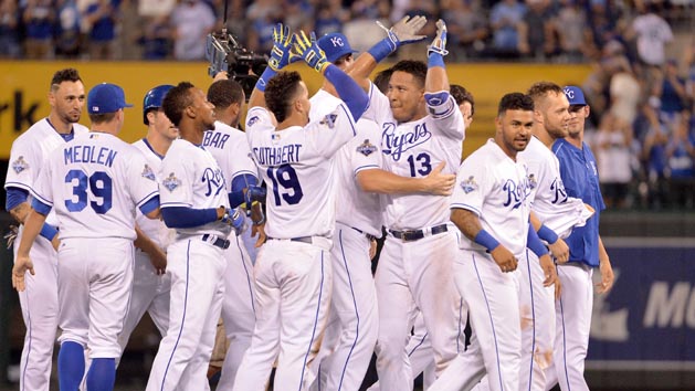 Jul 7, 2016; Kansas City, MO, USA; Kansas City Royals catcher Salvador Perez (13) is congratulated by third baseman Cheslor Cuthbert (19) and teammates after his two-run walk off double in the ninth inning against the Seattle Mariners at Kauffman Stadium. The Royals won 4-3. Photo Credit: Denny Medley-USA TODAY Sports