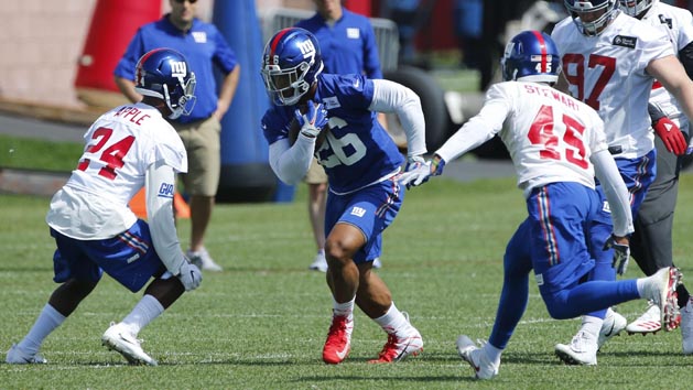 May 21, 2018; East Rutherford, NJ, USA; New York Giants running back Saquon Barkley (26) rushes against cornerback Eli Apple (24) and defensive back Orion Stewart (45) during practice at Quest Diagnostic Training Center. Photo Credit: Noah K. Murray-USA TODAY Sports