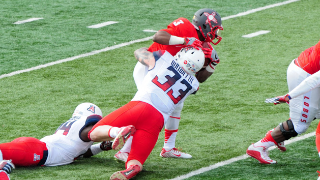 Dec 19, 2015; Albuquerque, NM, USA; Arizona Wildcats linebacker Scooby Wright III (33) tackles New Mexico Lobos running back Richard McQuarley (3) for a loss during the first half in the 2015 New Mexico Bowl at University Stadium. Mandatory Credit: Matt Kartozian-USA TODAY Sports