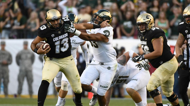 Sep 2, 2016; Denver, CO, USA; Colorado Buffaloes quarterback Sefo Liufau (13) stiff arms Colorado State Rams linebacker Kevin Davis (33) during a carry in the first quarter at Sports Authority Field. Photo Credit: Ron Chenoy-USA TODAY Sports