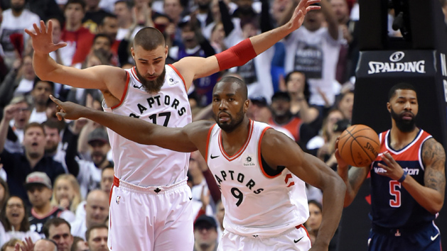 Apr 14, 2018; Toronto, Ontario, CAN; Toronto Raptors forward Serge Ibaka (9) and center Jonas Valanciunas (17) react after scoring against Washington Wizards in game one of the first round of the 2018 NBA Playoffs at Air Canada Centre. Photo Credit: Dan Hamilton-USA TODAY Sports