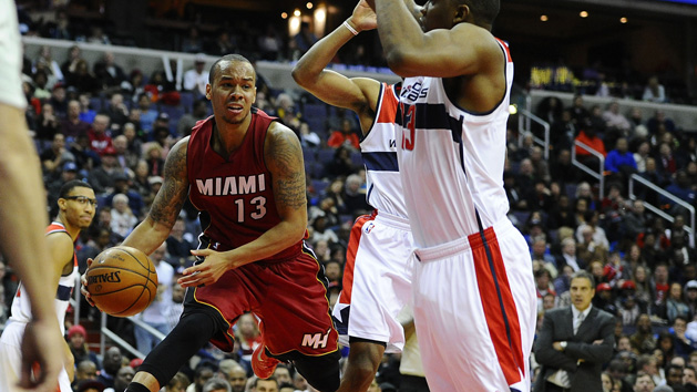 Mar 6, 2015; Washington, DC, USA; Miami Heat guard Shabazz Napier (13) passes the ball as Washington Wizards center Kevin Seraphin (13) defends during the second half at Verizon Center. Mandatory Credit: Brad Mills-USA TODAY Sports