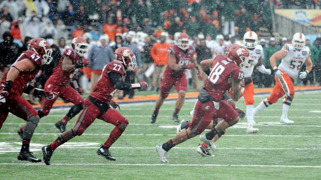 Dec 26, 2015; El Paso, TX, USA; Washington State Cougars safety Shalom Luani (18) returns an interception against the Miami Hurricanes during the second half at Sun Bowl Stadium. The Cougars won 20-14. Mandatory Credit: Joe Camporeale-USA TODAY Sports