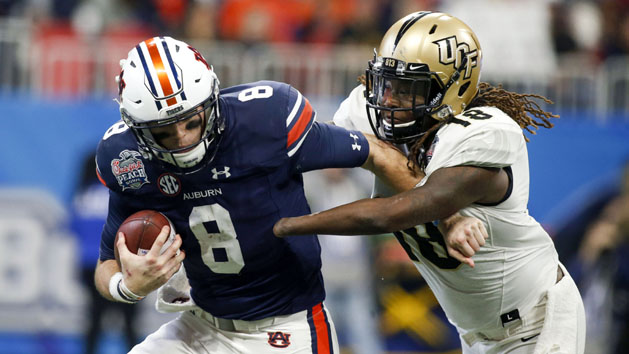 Jan 1, 2018; Atlanta, GA, USA; Auburn Tigers quarterback Jarrett Stidham (8) is sacked by Central Florida Knights linebacker Shaquem Griffin (18) in the second quarter in the 2018 Peach Bowl at Mercedes-Benz Stadium. Photo Credit: Brett Davis-USA TODAY Sports