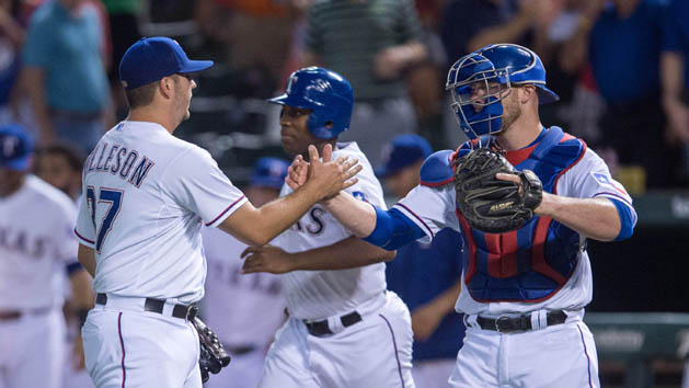 Jul 31, 2015; Arlington, TX, USA; Texas Rangers relief pitcher Shawn Tolleson (37) and catcher Chris Gimenez (38) celebrate the win over the San Francisco Giants at Globe Life Park in Arlington. The Rangers defeated the Giants 6-3. Photo Credit: Jerome Miron-USA TODAY Sports