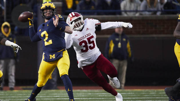 Nov 17, 2018; Ann Arbor, MI, USA; Michigan Wolverines quarterback Shea Patterson (2) passes under pressure by Indiana Hoosiers defensive lineman Nile Sykes (35) in the first half at Michigan Stadium. Photo Credit: Rick Osentoski-USA TODAY Sports