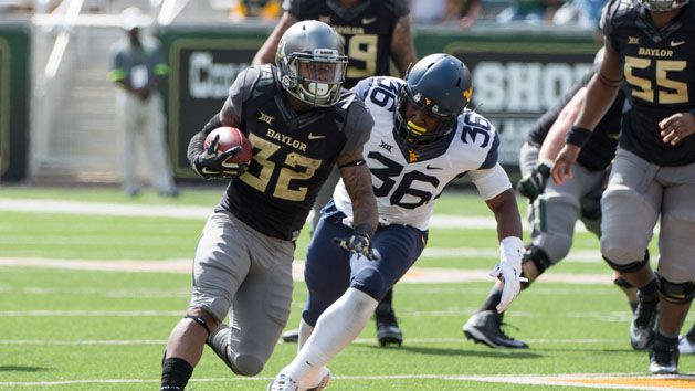 Oct 17, 2015; Waco, TX, USA; Baylor Bears running back Shock Linwood (32) eludes West Virginia Mountaineers linebacker Shaq Petteway (36) during the second half at McLane Stadium. The Bears defeat the Mountaineers 62-38. Mandatory Credit: Jerome Miron-USA TODAY Sports