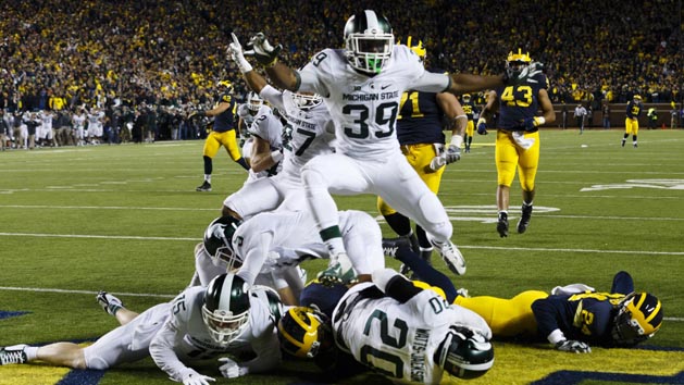 Oct 17, 2015; Ann Arbor, MI, USA; Michigan State Spartans defensive back Jalen Watts-Jackson (20) dives into the end zone for a game winning touchdown as the clock runs out in the fourth quarter against the Michigan Wolverines at Michigan Stadium. Michigan State 27-23. Mandatory Credit: Rick Osentoski-USA TODAY Sports
