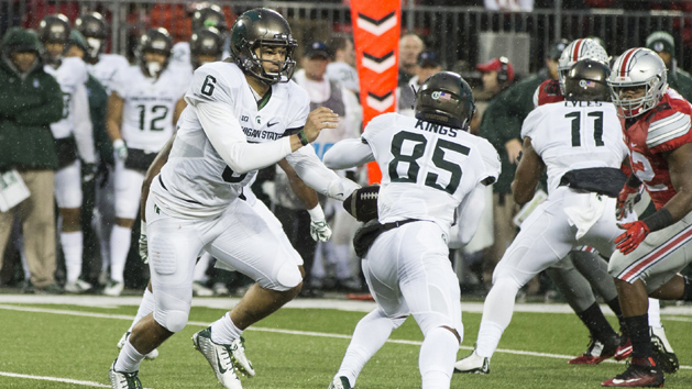 Nov 21, 2015; Columbus, OH, USA; Michigan State Spartans quarterback Damion Terry (6) hands the ball off to wide receiver Macgarrett Kings Jr. (85) during the game against the Ohio State Buckeyes at Ohio Stadium. Michigan State won the game 17-14. Mandatory Credit: Greg Bartram-USA TODAY Sports