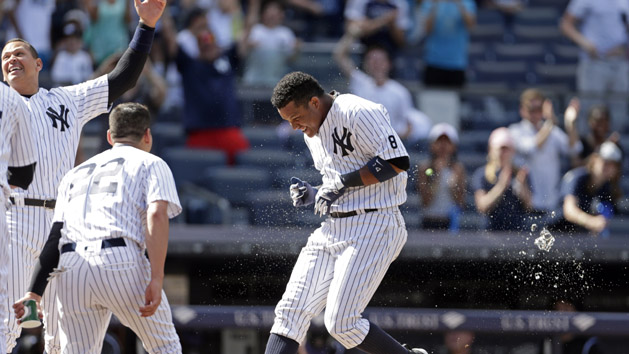 Jun 22, 2016; Bronx, NY, USA; New York Yankees second baseman Starlin Castro (14) celebrates hitting a walk off solo home run against the Colorado Rockies during the ninth inning of their inter-league game at Yankee Stadium. The Yankees won 9-8. Photo Credit: Adam Hunger-USA TODAY Sports
