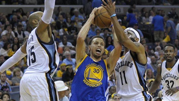 May 11, 2015; Memphis, TN, USA; Golden State Warriors guard Stephen Curry (30) goes to the basket against Memphis Grizzlies guard Mike Conley (11) and Memphis Grizzlies guard Vince Carter (15) during the game in game four of the second round of the NBA Playoffs at FedExForum. Golden State Warriors beat Memphis Grizzlies 101-84. Mandatory Credit: Justin Ford-USA TODAY Sports