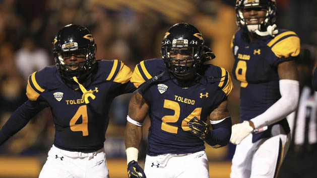 Sep 19, 2015; Toledo, OH, USA; Toledo Rockets wide receiver Corey Jones (4), running back Damion Jones-Moore (24) and wide receiver Alonzo Russell (9) celebrate after the game winning touchdown during the fourth at Glass Bowl. Toledo Rockets defeated Iowa State Cyclones 30-23. Mandatory Credit: Andrew Weber-USA TODAY Sports