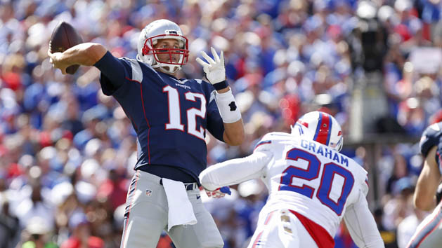 Sep 20, 2015; Orchard Park, NY, USA; New England Patriots quarterback Tom Brady (12) throws a pass as Buffalo Bills free safety Corey Graham (20) rushes during the first quarter at Ralph Wilson Stadium. Mandatory Credit: Kevin Hoffman-USA TODAY Sports