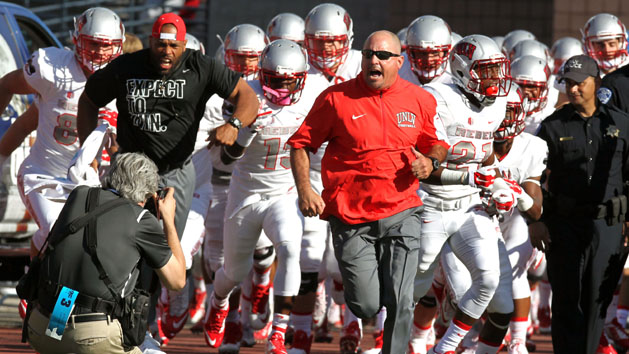 Oct 3, 2015; Reno, NV, USA; UNLV Rebels head coach Tony Sanchez Leeds his team onto the field prior to the start of their NCAA football game with the Nevada Wolf Pack at MacKay Stadium. Mandatory Credit: Lance Iversen-USA TODAY Sports