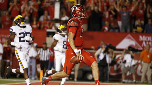 Sep 3, 2015; Salt Lake City, UT, USA; Utah Utes quarterback Travis Wilson (7) runs in for a touchdown against the Michigan Wolverines in the third quarter at Rice-Eccles Stadium. Mandatory Credit: Jeff Swinger-USA TODAY Sports