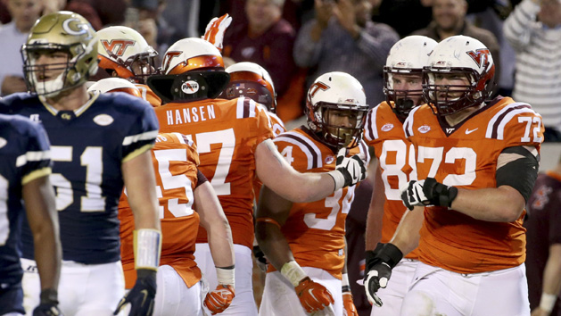 Nov 12, 2015; Atlanta, GA, USA; Virginia Tech Hokies running back Travon McMillian (34) celebrates a touchdown run with offensive lineman Wade Hansen (77) in the second quarter of their game against the Georgia Tech Yellow Jackets at Bobby Dodd Stadium. The Hokies defeated the Yellow Jackets 23-21. Mandatory Credit: Jason Getz-USA TODAY Sports