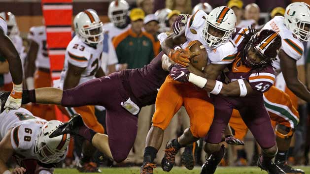 Oct 20, 2016; Blacksburg, VA, USA; Miami Hurricanes running back Mark Walton (1) is tackled by Virginia Tech Hokies linebacker Tremaine Edmunds (49) during the first quarter at Lane Stadium. Photo Credit: Peter Casey-USA TODAY Sports