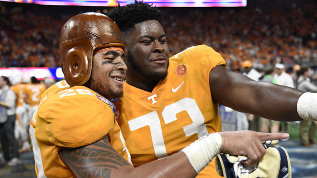Sep 4, 2017; Atlanta, GA, USA; Tennessee Volunteers linebacker Cortez McDowell (20) wears the old leather helmet as he and offensive lineman Trey Smith (73) react after defeating the Georgia Tech Yellow Jackets at Mercedes-Benz Stadium. Tennessee won 42-41 in two overtimes. Mandatory Credit: Dale Zanine-USA TODAY Sports