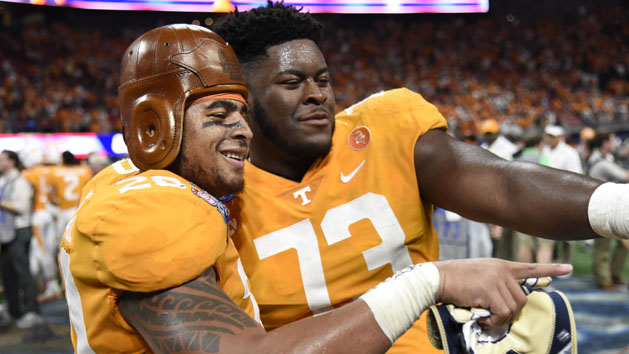 Sep 4, 2017; Atlanta, GA, USA; Tennessee Volunteers linebacker Cortez McDowell (20) wears the old leather helmet as he and offensive lineman Trey Smith (73) react after defeating the Georgia Tech Yellow Jackets at Mercedes-Benz Stadium. Tennessee won 42-41 in two overtimes. Photo Credit: Dale Zanine-USA TODAY Sports