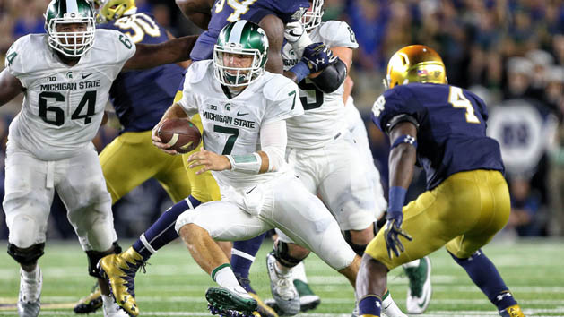 Sep 17, 2016; South Bend, IN, USA; Michigan State Spartans quarterback Tyler O'Connor (7) runs the ball against Notre Dame Fighting Irish linebacker Te'von Coney during the first half a game at Notre Dame Stadium. Photo Credit: Mike Carter-USA TODAY Sports