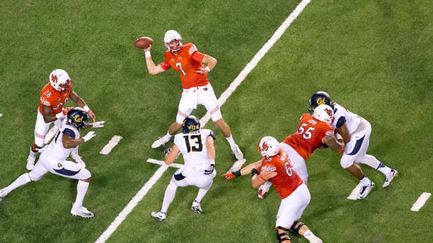 Oct 10, 2015; Salt Lake City, UT, USA; Utah Utes quarterback Travis Wilson (7) throws a touchdown pass as running back Joe Williams (28) and offensive lineman Hiva Lutui (55) and offensive lineman J.J. Dielman (68) block during the first half against the California Golden Bears at Rice-Eccles Stadium. Mandatory Credit: Russ Isabella-USA TODAY Sports