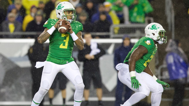 Nov 7, 2015; Eugene, OR, USA; Oregon Ducks quarterback Vernon Adams Jr. (3) throws the ball as Ducks running back Royce Freeman (21) defends against the California Golden Bears at Autzen Stadium. Mandatory Credit: Scott Olmos-USA TODAY Sports
