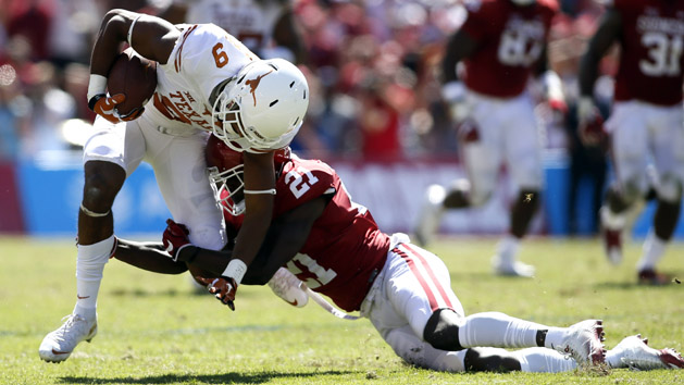 Oct 8, 2016; Dallas, TX, USA; Texas Longhorns wide receiver Collin Johnson (9) is tackled by Oklahoma Sooners safety Will Sunderland (21) in the second quarter at Cotton Bowl. Photo Credit: Tim Heitman-USA TODAY Sports