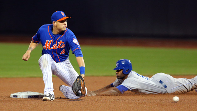 Nov 1, 2015; New York City, NY, USA; Kansas City Royals center fielder Lorenzo Cain (6) steals second base ahead of the throw to New York Mets shortstop Wilmer Flores (4) in the 9th inning in game five of the World Series at Citi Field. Mandatory Credit: Brad Penner-USA TODAY Sports